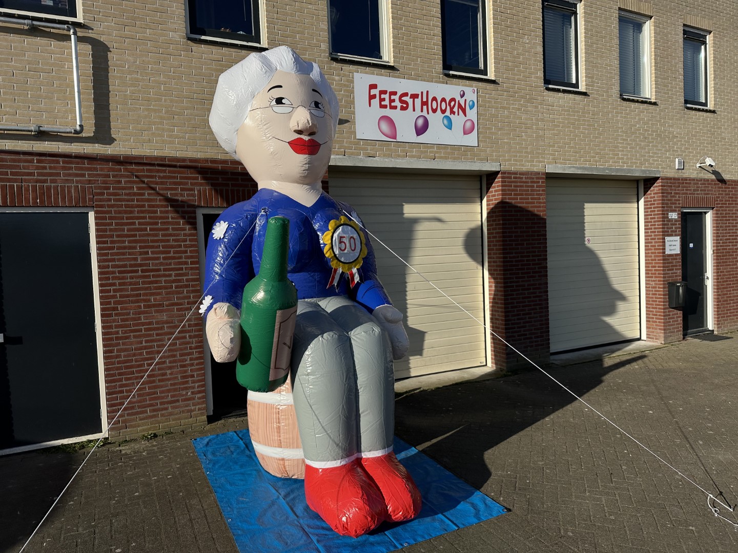 De Sarah op Wijnvat, zittend op een wijnvat met een hoogte: 3.8 meter. Standaard geleverd met leeftijd rozet ’50’. De leeftijd-rozet kan aan iedere leeftijd worden aangepast.